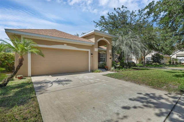 215 Foxglove Way, Deland, FL 32724 - view of front facade featuring stucco siding, a garage, driveway, and a front yard