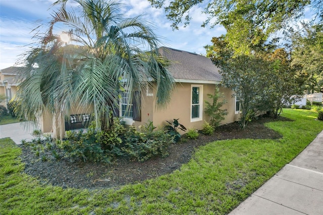 215 Foxglove Way, Deland, FL 32724 - view of property exterior featuring stucco siding and a yard