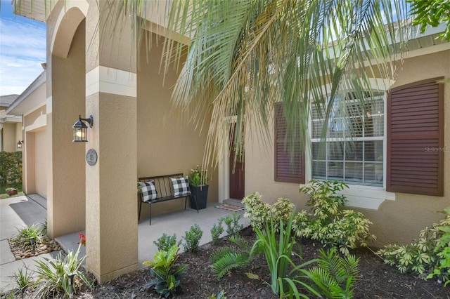 215 Foxglove Way, Deland, FL 32724 - doorway to property with stucco siding and covered porch