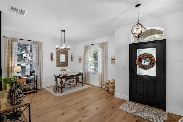 215 Foxglove Way, Deland, FL 32724 - entrance foyer featuring a chandelier and light wood-style floors