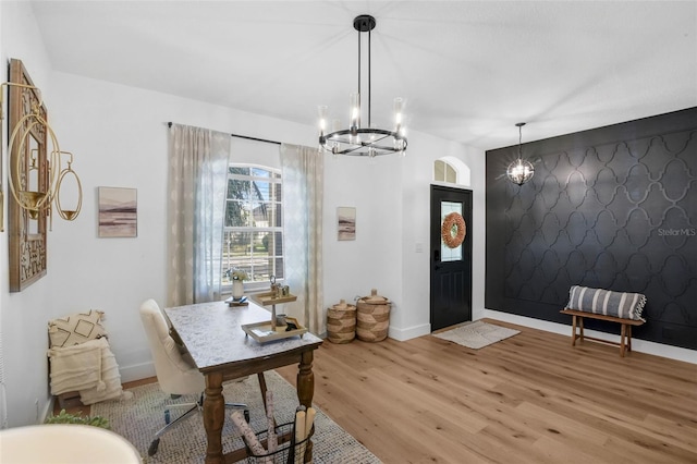 215 Foxglove Way, Deland, FL 32724 - foyer featuring an accent wall, a chandelier, and light wood-style flooring