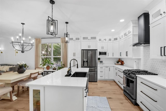 215 Foxglove Way, Deland, FL 32724 - kitchen with stainless steel appliances, wall chimney range hood, light countertops, a kitchen island with sink, and recessed lighting