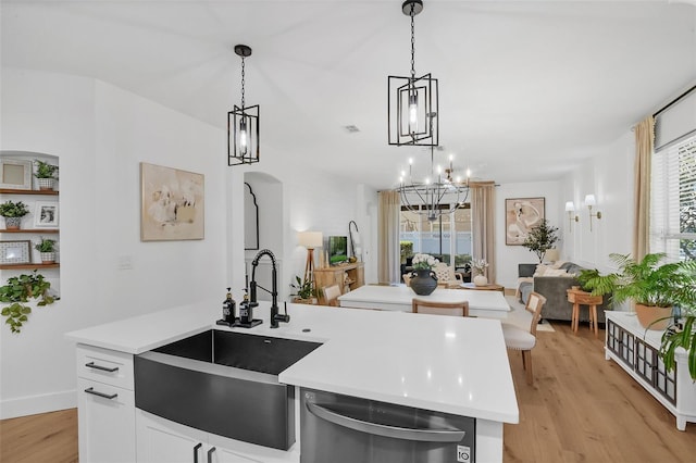 215 Foxglove Way, Deland, FL 32724 - kitchen featuring stainless steel dishwasher, light countertops, light wood finished floors, open floor plan, and plenty of natural light