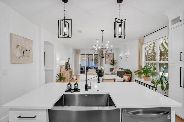 215 Foxglove Way, Deland, FL 32724 - kitchen featuring stainless steel dishwasher, light countertops, open floor plan, a chandelier, and arched walkways