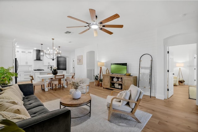 215 Foxglove Way, Deland, FL 32724 - living area featuring a ceiling fan, light wood-type flooring, and arched walkways