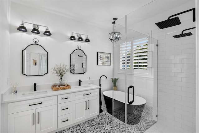 215 Foxglove Way, Deland, FL 32724 - full bath featuring a stall shower, a freestanding bath, double vanity, and tile patterned floors