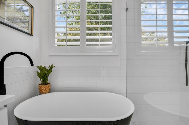 215 Foxglove Way, Deland, FL 32724 - full bath featuring a freestanding bath, plenty of natural light, and tile walls