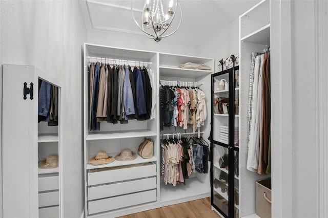 215 Foxglove Way, Deland, FL 32724 - walk in closet featuring wood finished floors and a chandelier