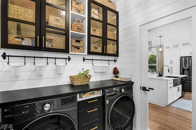 215 Foxglove Way, Deland, FL 32724 - washroom featuring washer and clothes dryer, light wood finished floors, and wood walls