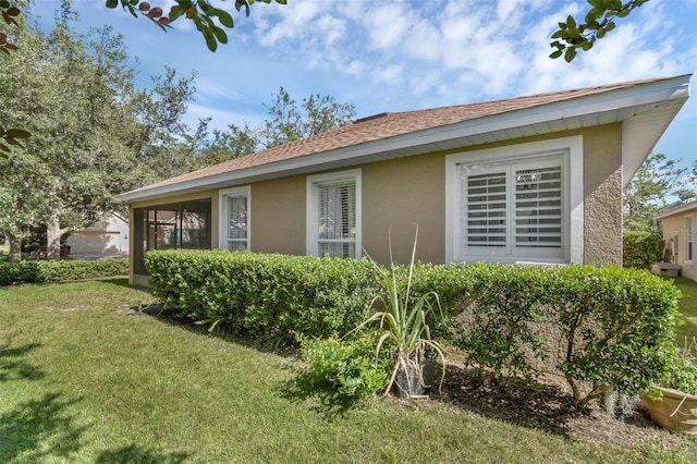215 Foxglove Way, Deland, FL 32724 - view of home's exterior featuring a yard, stucco siding, a sunroom, and a shingled roof