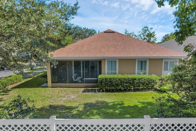 215 Foxglove Way, Deland, FL 32724 - rear view of house with a yard, stucco siding, a sunroom, and roof with shingles