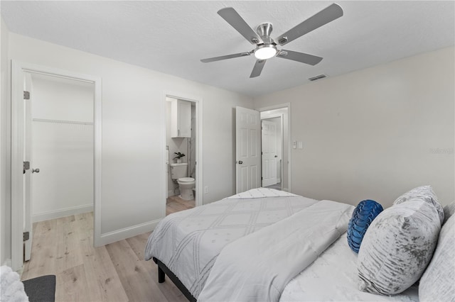 2075 Abalone Ave, Indialantic, FL 32903 - bedroom featuring light wood-style flooring, a closet, a spacious closet, a ceiling fan, and ensuite bathroom