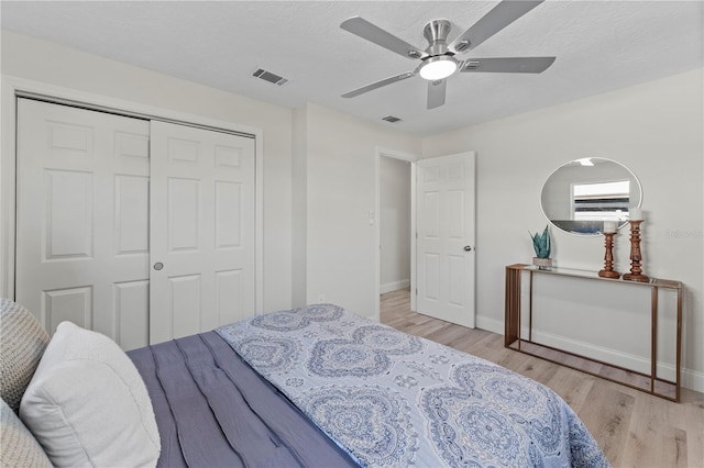 2075 Abalone Ave, Indialantic, FL 32903 - bedroom with wood finished floors, a closet, a ceiling fan, and a textured ceiling