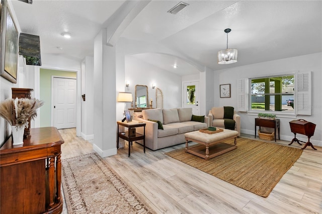 4230 Havana Dr, Cocoa, FL 32927 - living area featuring arched walkways, light wood-style floors, and a chandelier
