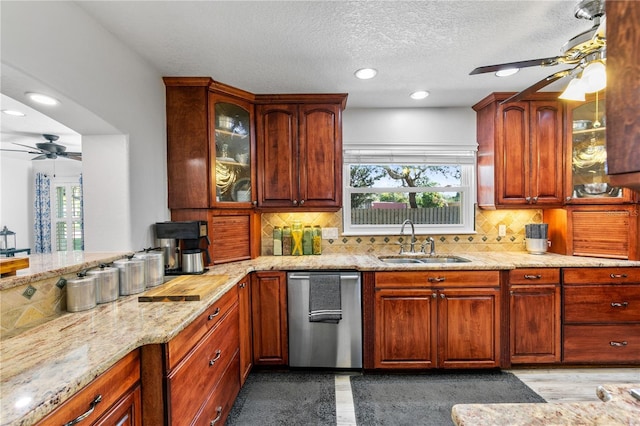 4230 Havana Dr, Cocoa, FL 32927 - kitchen featuring a ceiling fan, light stone counters, stainless steel dishwasher, backsplash, and a textured ceiling
