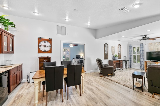 4230 Havana Dr, Cocoa, FL 32927 - dining area with ceiling fan, light wood-style flooring, and a textured ceiling