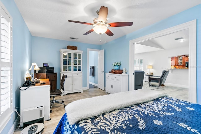 4230 Havana Dr, Cocoa, FL 32927 - bedroom featuring light wood finished floors, a desk, a ceiling fan, and a textured ceiling