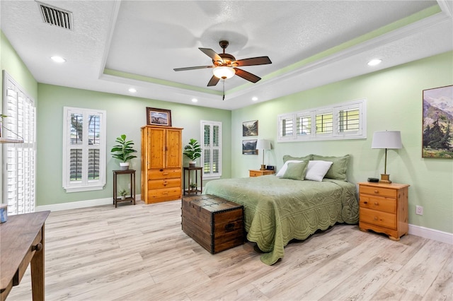 4230 Havana Dr, Cocoa, FL 32927 - bedroom featuring light wood-style flooring, a raised ceiling, a textured ceiling, recessed lighting, and a ceiling fan