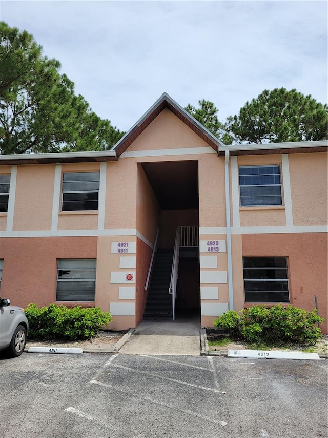 4921 Pinewood Dr NE Unit 8, Palm Bay, FL 32905 - view of building exterior with uncovered parking