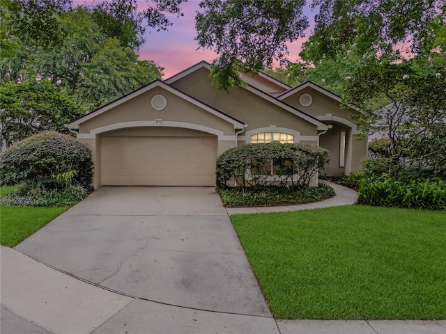 871 Paddington Ter, Lake Mary, FL 32746 - view of front facade featuring a yard, stucco siding, a garage, and driveway