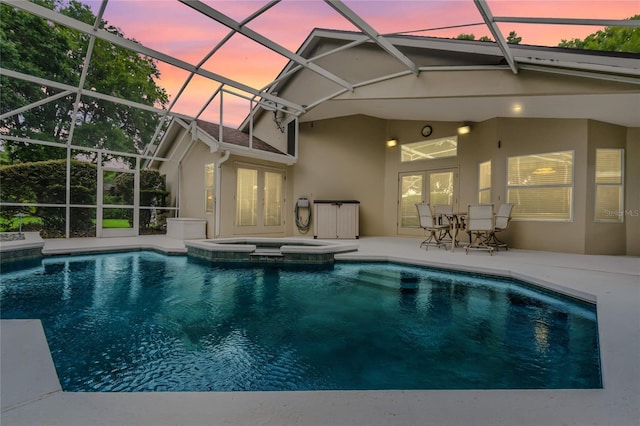 871 Paddington Ter, Lake Mary, FL 32746 - pool at dusk with french doors, a patio, a pool with connected hot tub, and a lanai