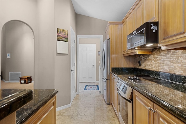 871 Paddington Ter, Lake Mary, FL 32746 - kitchen with stainless steel appliances, arched walkways, tasteful backsplash, and dark stone countertops