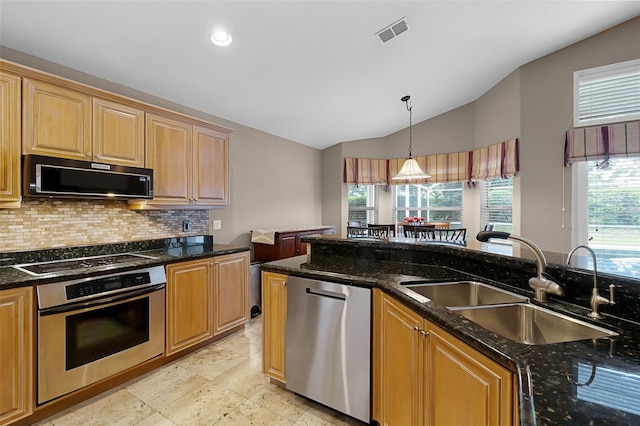 871 Paddington Ter, Lake Mary, FL 32746 - kitchen with black appliances, vaulted ceiling, tasteful backsplash, decorative light fixtures, and dark stone countertops