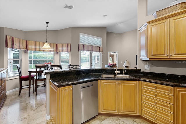 871 Paddington Ter, Lake Mary, FL 32746 - kitchen with stainless steel dishwasher, lofted ceiling, a peninsula, dark stone countertops, and pendant lighting