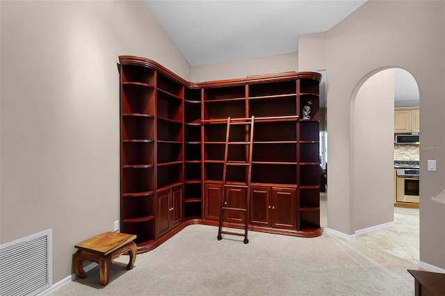 871 Paddington Ter, Lake Mary, FL 32746 - unfurnished room with light carpet, arched walkways, and lofted ceiling