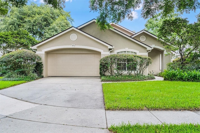871 Paddington Ter, Lake Mary, FL 32746 - view of front facade featuring stucco siding, an attached garage, a front lawn, and concrete driveway