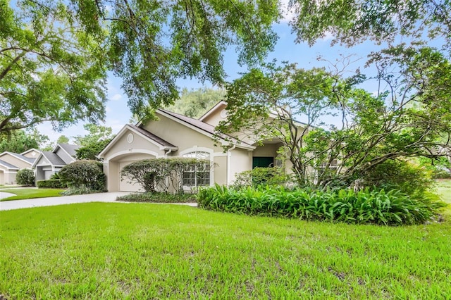 871 Paddington Ter, Lake Mary, FL 32746 - view of front of home featuring driveway, stucco siding, a front yard, and an attached garage