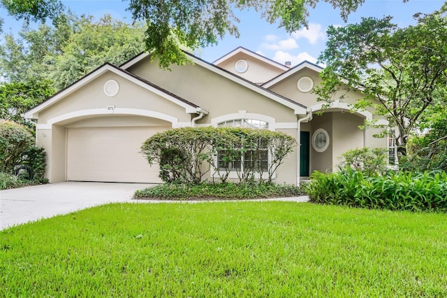 871 Paddington Ter, Lake Mary, FL 32746 - view of front facade featuring an attached garage, stucco siding, a front lawn, and concrete driveway