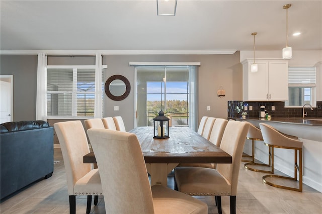 4185 Paragraph Dr, Kissimmee, FL 34746 - dining room with healthy amount of natural light, crown molding, and light tile patterned floors