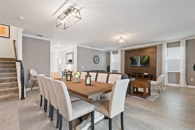 4185 Paragraph Dr, Kissimmee, FL 34746 - dining area featuring ornamental molding and stairway