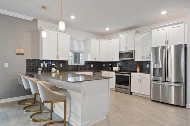 4185 Paragraph Dr, Kissimmee, FL 34746 - kitchen featuring appliances with stainless steel finishes, a peninsula, white cabinetry, backsplash, and recessed lighting