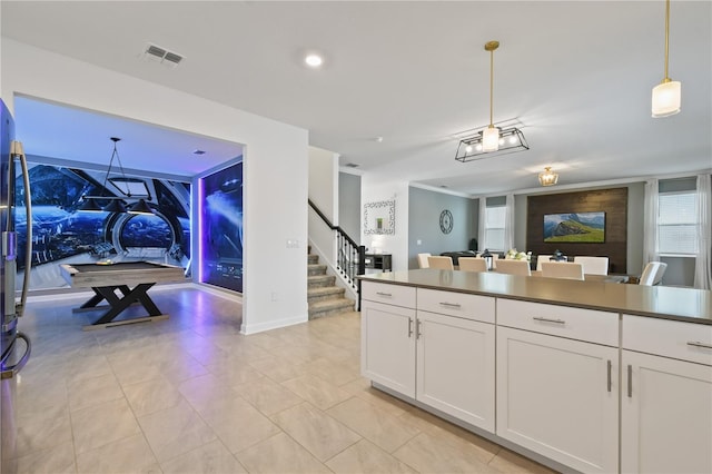 4185 Paragraph Dr, Kissimmee, FL 34746 - kitchen featuring open floor plan, white cabinets, decorative light fixtures, and dark countertops
