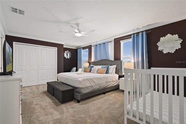 4185 Paragraph Dr, Kissimmee, FL 34746 - bedroom with carpet flooring, ornamental molding, a closet, and ceiling fan