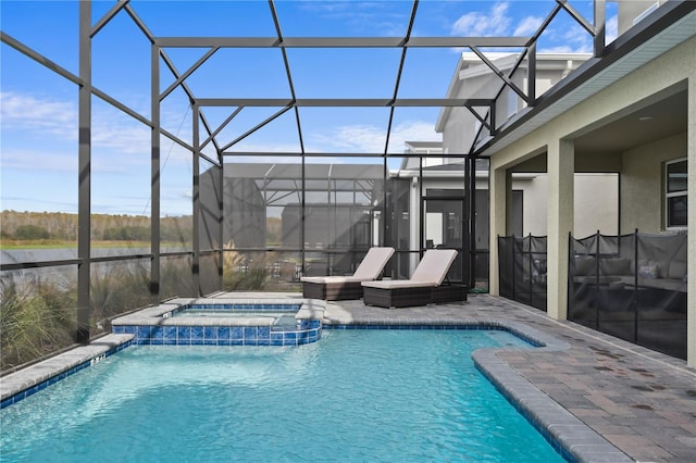4185 Paragraph Dr, Kissimmee, FL 34746 - view of swimming pool featuring a pool with connected hot tub, glass enclosure, and a patio