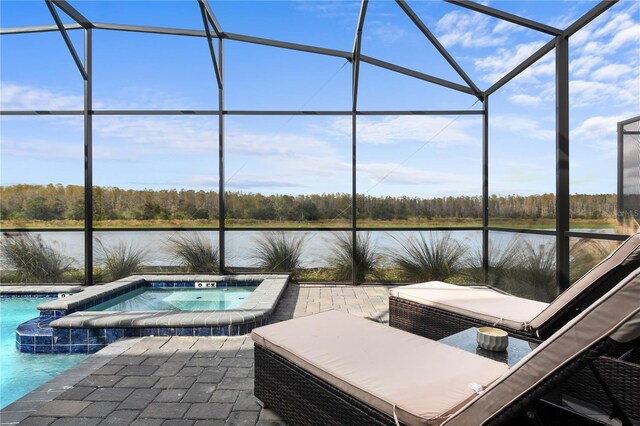 4185 Paragraph Dr, Kissimmee, FL 34746 - view of pool featuring glass enclosure, a water view, a patio area, and a pool with connected hot tub