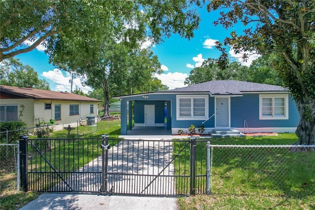207 Kay St, Auburndale, FL 33823 - view of front of home with a fenced front yard, a carport, concrete driveway, and a gate