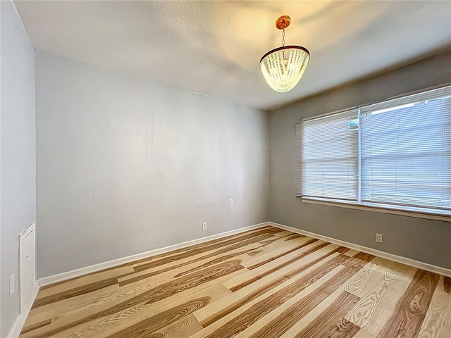 207 Kay St, Auburndale, FL 33823 - empty room featuring light wood finished floors and a chandelier