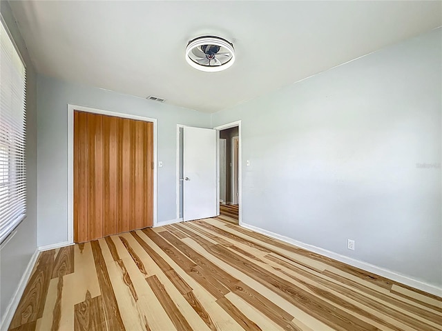 207 Kay St, Auburndale, FL 33823 - unfurnished bedroom featuring a closet and light wood finished floors
