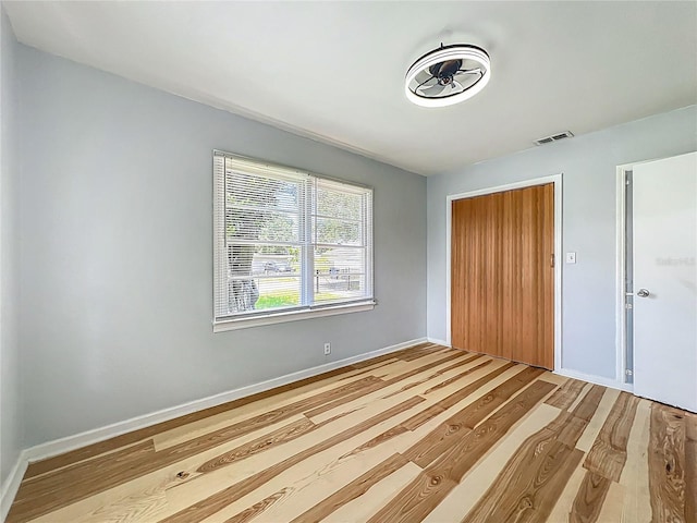 207 Kay St, Auburndale, FL 33823 - unfurnished bedroom featuring a closet and wood finished floors