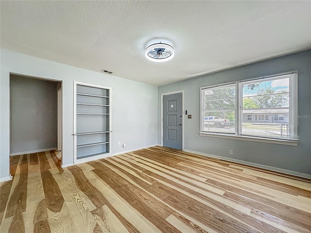 207 Kay St, Auburndale, FL 33823 - unfurnished bedroom featuring wood finished floors and a textured ceiling