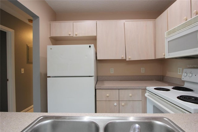 1131 S Pine Ridge Cir Unit 1, Sanford, FL 32773 - kitchen with white appliances, light countertops, and light brown cabinets