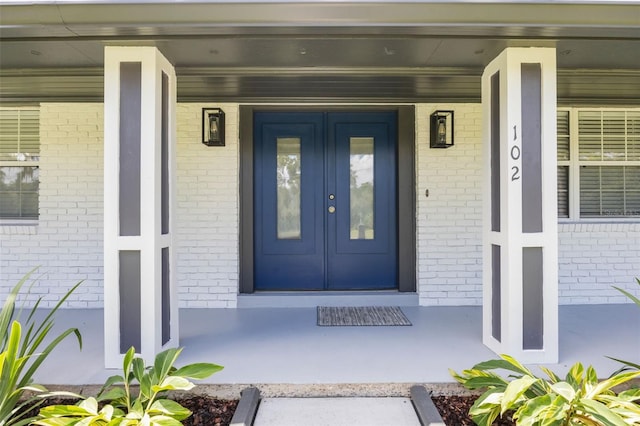 102 Linda Ln, Lake Mary, FL 32746 - entrance to property featuring french doors, brick siding, and covered porch