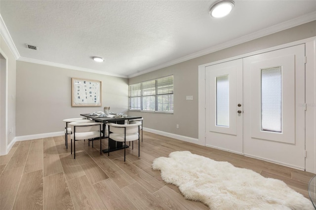 102 Linda Ln, Lake Mary, FL 32746 - dining room with crown molding, light wood-type flooring, a textured ceiling, and french doors