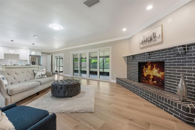102 Linda Ln, Lake Mary, FL 32746 - living room with crown molding, a warm lit fireplace, light wood finished floors, and recessed lighting