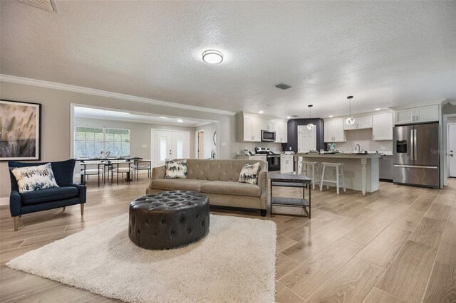 102 Linda Ln, Lake Mary, FL 32746 - living area with ornamental molding, a textured ceiling, light wood-type flooring, and recessed lighting