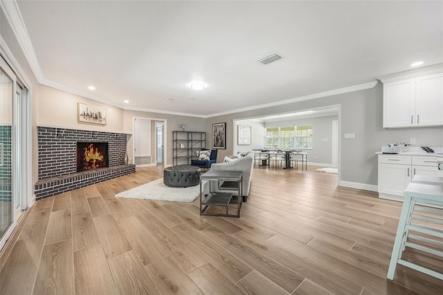 102 Linda Ln, Lake Mary, FL 32746 - living area with light wood-style floors, ornamental molding, a fireplace, and recessed lighting